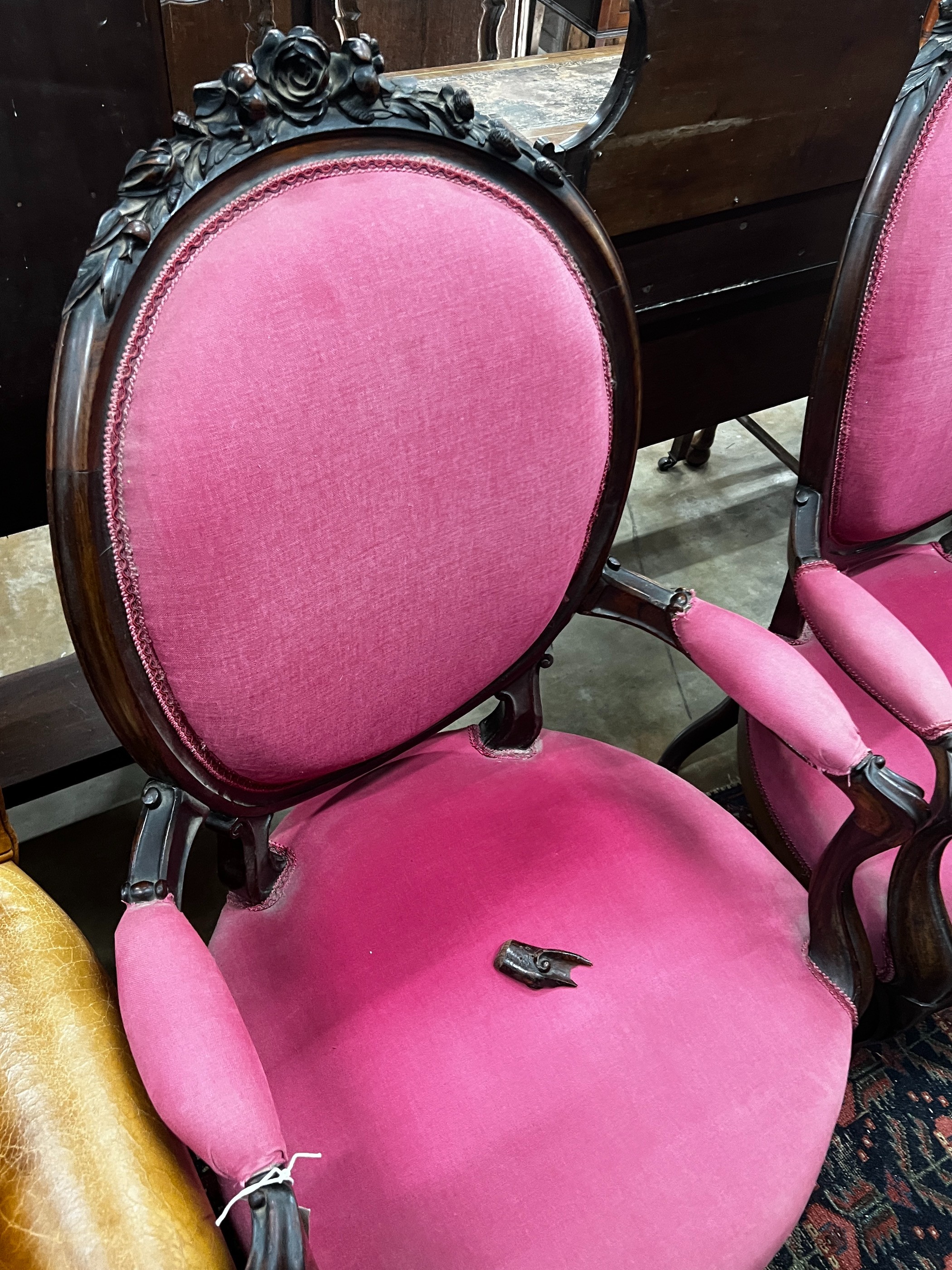 A near pair of 19th century French rosewood upholstered armchairs, larger width 61cm, depth 56cm, height 108cm